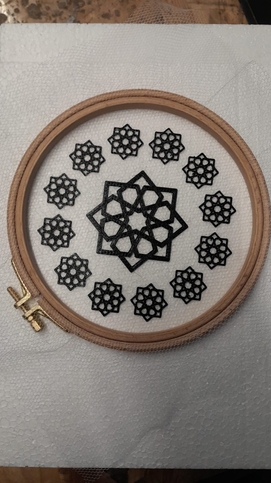 Final composition displayed in an embroidery hoop