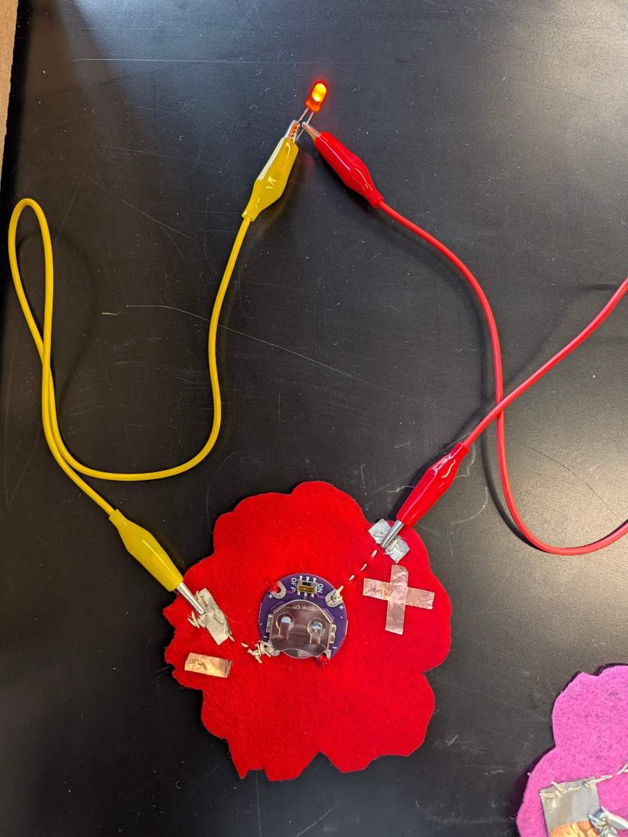 Testing the textile power module with an external LED connected using alligator clips