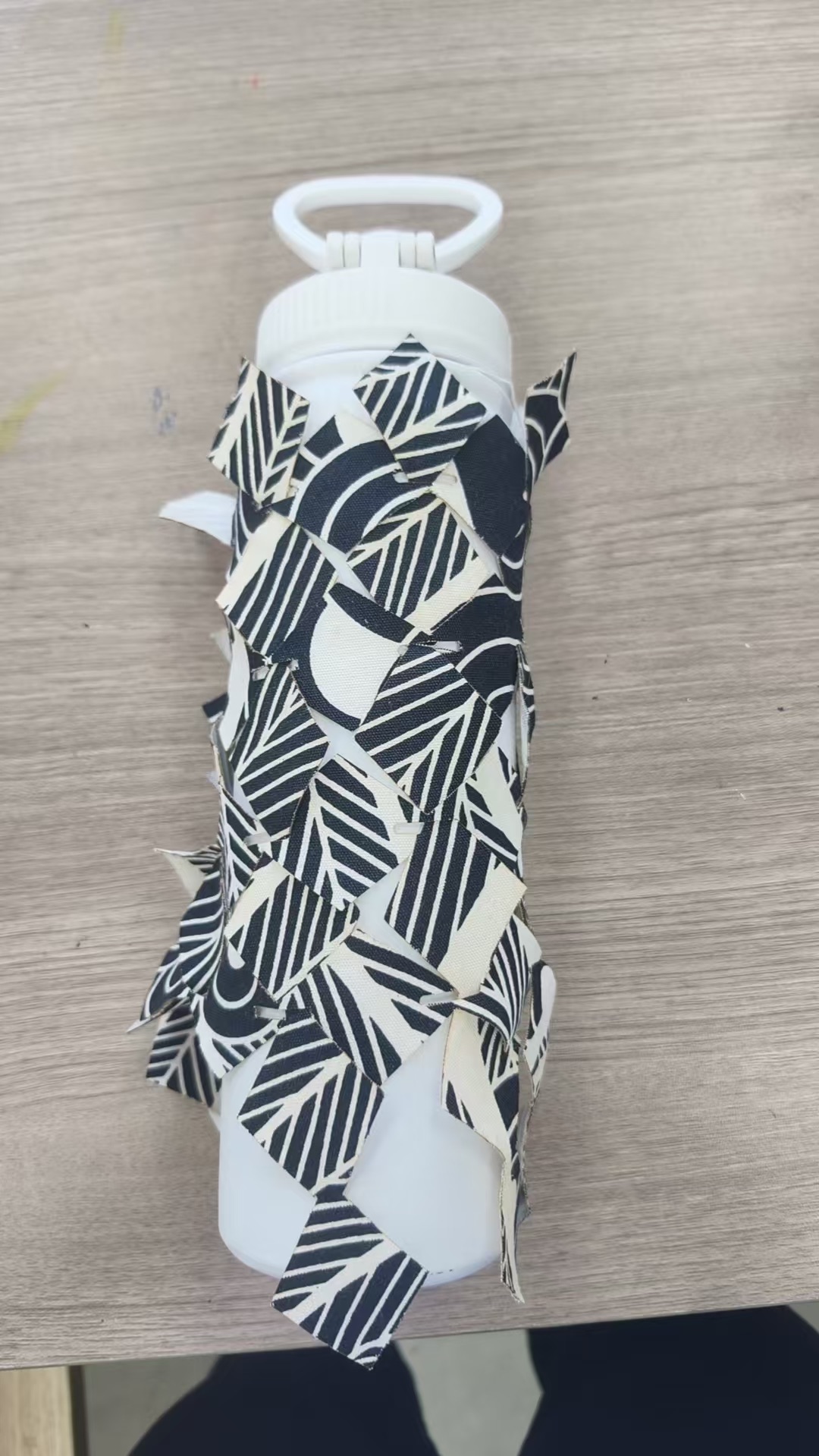 The same textile wrapped around a water bottle