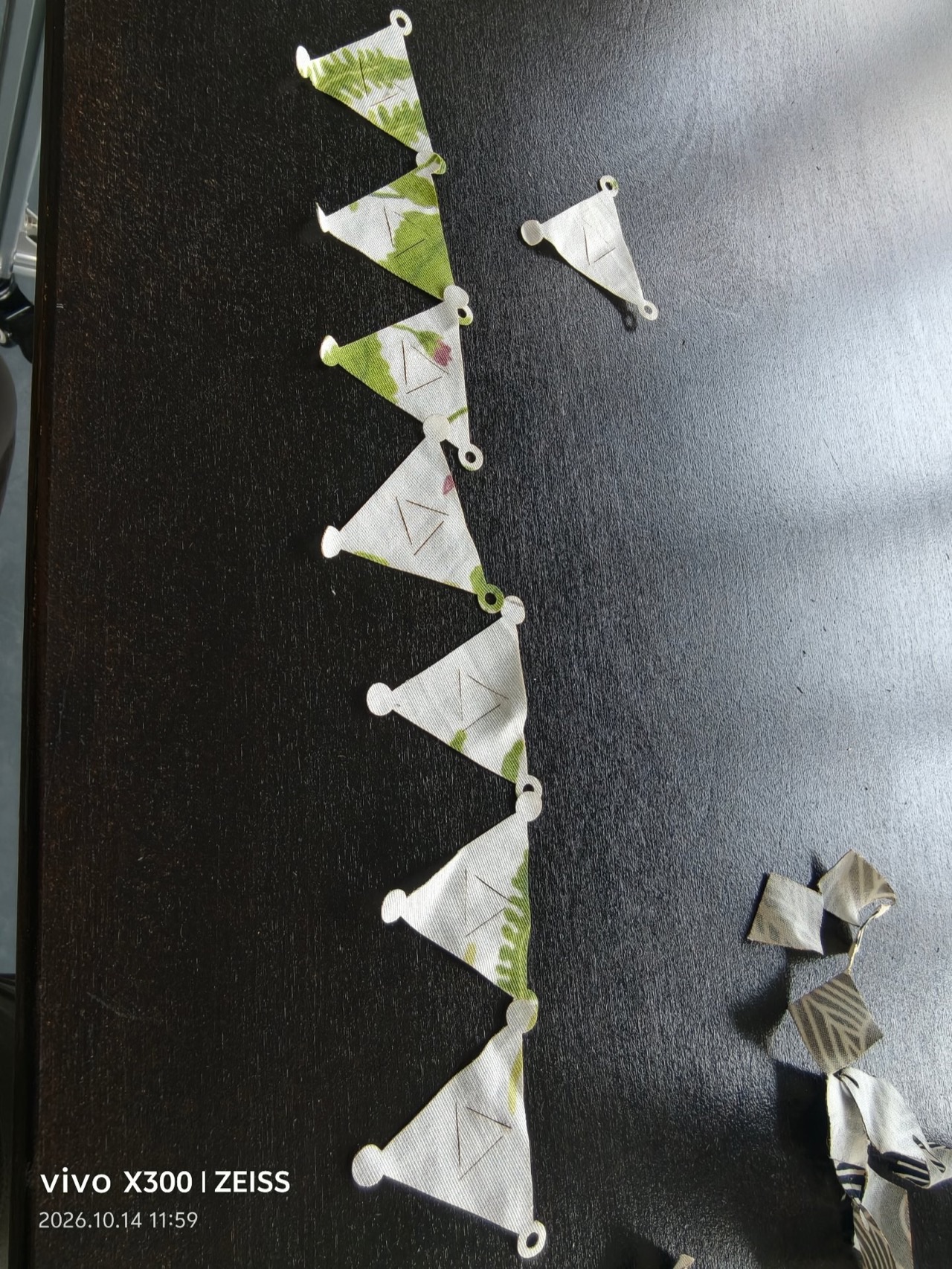 A vertical chain of linked modules on the dark table — printed ferns and florals