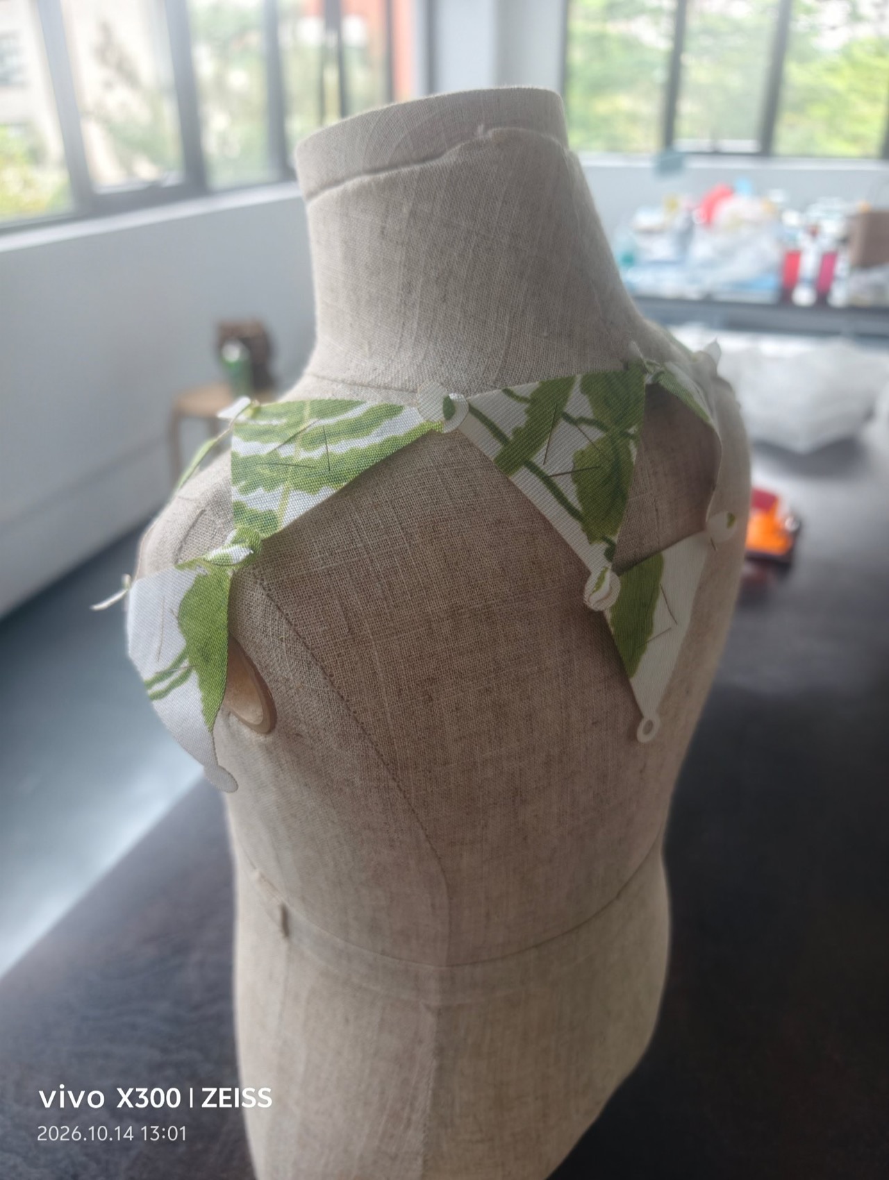 The bib from the shoulder — modules fanning over the shoulder line