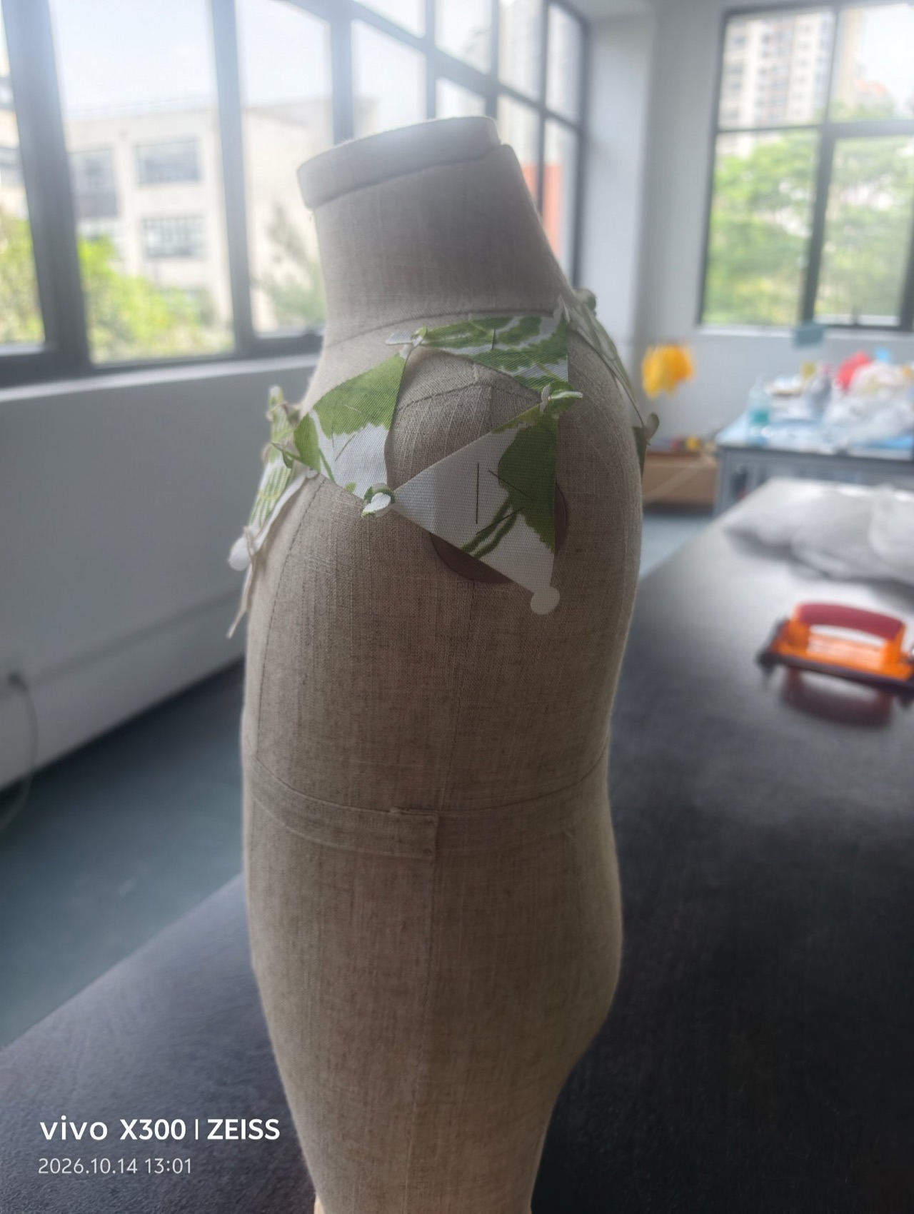 The modular bib on the dress form — side view