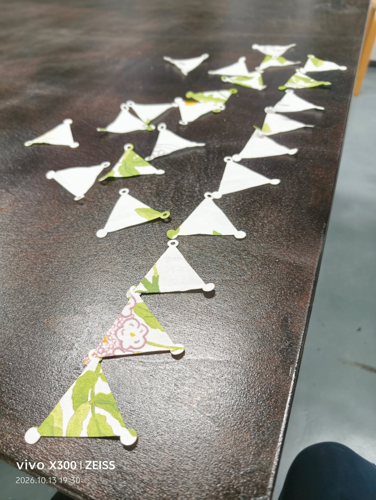 Cut bougainvillea modules scattered across the worktable