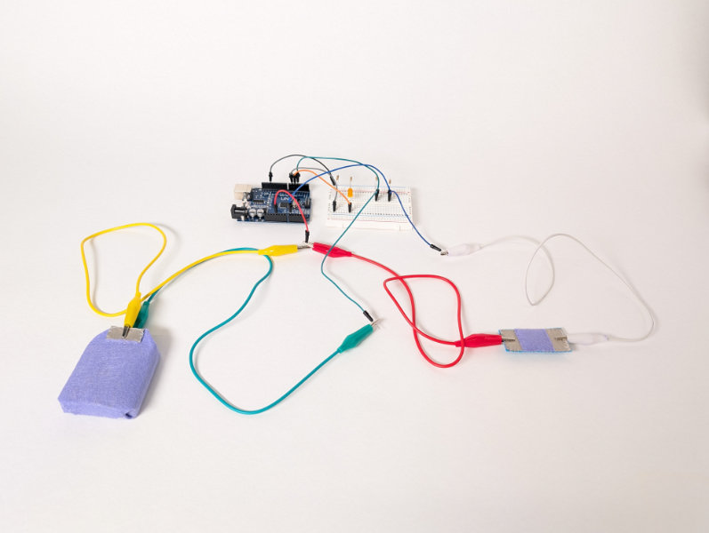 wires connecting purple felt box and purpe/silver rectangle to white breadboard and arduino uno
